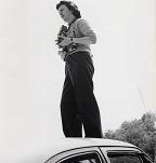 Bubley standing on a car roof with cameras