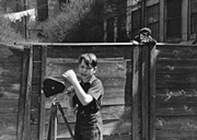 filming, one looking over fence